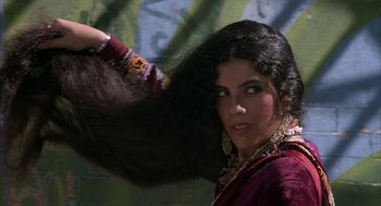 Movie still from “Hair” (1979), directed by Milos Forman – A woman is combing her long hair with a brush; Close Up shot, Low angle
