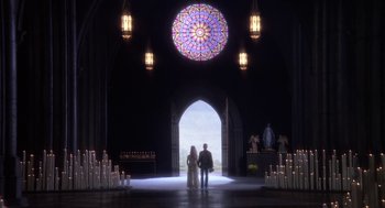 Movie still from “Hair” (1979), directed by Milos Forman – Two people standing in front of a stained - glass window; Wide shot, High angle