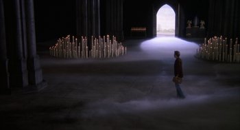 Movie still from “Hair” (1979), directed by Milos Forman – A man is walking through a tunnel of candles; Extreme Wide shot, High angle