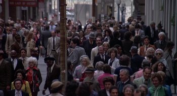 Movie still from “Hair” (1979), directed by Milos Forman – A crowd of people walking down a street; Extreme Wide shot, High angle