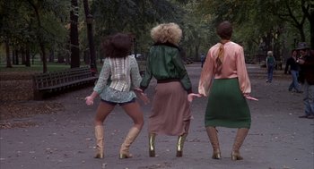 Movie still from “Hair” (1979), directed by Milos Forman – A group of three women walking down a street; Wide shot, Low angle
