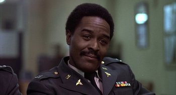 Movie still from “Hair” (1979), directed by Milos Forman – A person wearing a military uniform; Close Up shot, Low angle