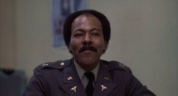 Movie still from “Hair” (1979), directed by Milos Forman – A man in a military uniform with a mustache; Close Up shot, Low angle