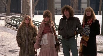 Movie still from “Hair” (1979), directed by Milos Forman – A group of people standing next to each other on a snowy day; Medium shot, Low angle