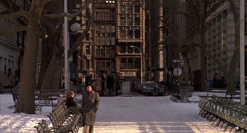 Movie still from “Hair” (1979), directed by Milos Forman – A man standing next to a bench in the snow; Extreme Wide shot, High angle