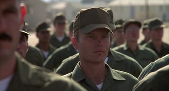 Movie still from “Hair” (1979), directed by Milos Forman – A group of men in green fatigues and hats; Close Up shot, Low angle
