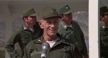 Movie still from “Hair” (1979), directed by Milos Forman – An older man in a military uniform is speaking; Close Up shot, Low angle