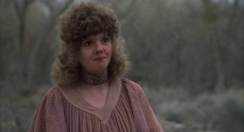 Movie still from “Hair” (1979), directed by Milos Forman – A woman in a pink dress and a silver necklace; Close Up shot, Low angle