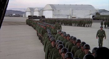 Movie still from “Hair” (1979), directed by Milos Forman – A large group of men in green uniforms; Extreme Wide shot, High angle
