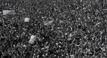 Movie still from “Hair” (1979), directed by Milos Forman – A large crowd of people gathered in a field; Extreme Wide shot, High angle