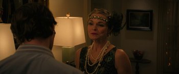 Movie still from “Halloween Ends” (2022), directed by David Gordon Green – A woman in a black dress wearing pearls and a head piece; Close Up shot, Over the shoulder angle