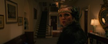 Movie still from “Halloween Ends” (2022), directed by David Gordon Green – A woman in a black fur coat and a gold head piece; Close Up shot, Low angle