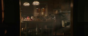 Movie still from “Halloween Ends” (2022), directed by David Gordon Green – A woman standing in front of a counter in a kitchen; Wide shot, High angle