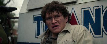 Movie still from “Halloween Ends” (2022), directed by David Gordon Green – A man with glasses and a messy hair style; Close Up shot, Low angle