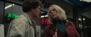 Movie still from “Halloween Ends” (2022), directed by David Gordon Green – A man and a woman standing next to each other; Close Up shot, Over the shoulder angle