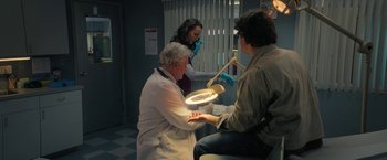 Movie still from “Halloween Ends” (2022), directed by David Gordon Green – A dentist showing a patient how to brush his teeth; Medium shot, High angle