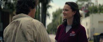Movie still from “Halloween Ends” (2022), directed by David Gordon Green – A woman in a red shirt talking to a man in a brown shirt; Close Up shot, Over the shoulder angle