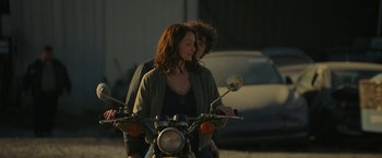 Movie still from “Halloween Ends” (2022), directed by David Gordon Green – A man and a woman on a motor bike; Medium shot, Over the shoulder angle