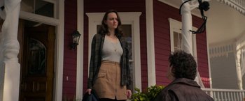 Movie still from “Halloween Ends” (2022), directed by David Gordon Green – A woman standing in front of a red house; Medium shot, Over the shoulder angle