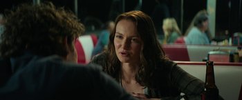 Movie still from “Halloween Ends” (2022), directed by David Gordon Green – A woman sitting in front of a man at a table; Close Up shot, Over the shoulder angle
