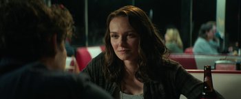 Movie still from “Halloween Ends” (2022), directed by David Gordon Green – A person sitting at a table; Close Up shot, Over the shoulder angle