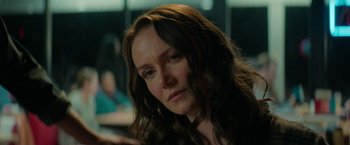 Movie still from “Halloween Ends” (2022), directed by David Gordon Green – A person with long brown hair; Close Up shot, Over the shoulder angle