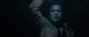 Movie still from “Halloween Ends” (2022), directed by David Gordon Green – A man in a brown and green jacket is in the dark; Close Up shot, Overhead angle