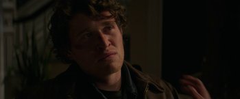 Movie still from “Halloween Ends” (2022), directed by David Gordon Green – A person wearing a brown jacket; Close Up shot, Over the shoulder angle