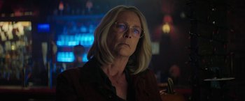 Movie still from “Halloween Ends” (2022), directed by David Gordon Green – An older woman wearing glasses looking at the camera; Close Up shot, Low angle