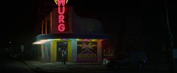 Movie still from “Halloween Ends” (2022), directed by David Gordon Green – A man standing in front of a building at night; Extreme Wide shot, Low angle