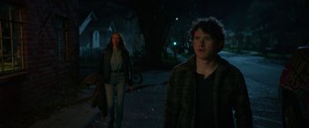 Movie still from “Halloween Ends” (2022), directed by David Gordon Green – A man and a woman walking down a street at night; Medium shot, Low angle