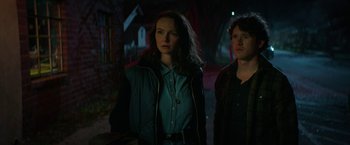 Movie still from “Halloween Ends” (2022), directed by David Gordon Green – A woman and a man standing next to each other in the dark; Medium shot, Low angle