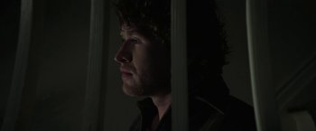 Movie still from “Halloween Ends” (2022), directed by David Gordon Green – A person looking out a window; Close Up shot, Low angle