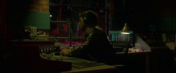Movie still from “Halloween Ends” (2022), directed by David Gordon Green – A man wearing a leather jacket sitting at a table; Medium shot, High angle