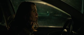 Movie still from “Halloween Ends” (2022), directed by David Gordon Green – A woman sitting in the driver's seat of a car at night; Close Up shot, Over the shoulder angle