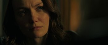 Movie still from “Halloween Ends” (2022), directed by David Gordon Green – A woman's face with green eyes; Close Up shot, Over the shoulder angle
