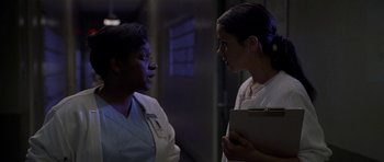 Movie still from “Halloween: Resurrection” (2002), directed by Rick Rosenthal – Two women are talking to each other in a dark room; Close Up shot, Low angle
