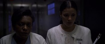 Movie still from “Halloween: Resurrection” (2002), directed by Rick Rosenthal – Two women standing next to each other in front of a wall; Close Up shot, Low angle
