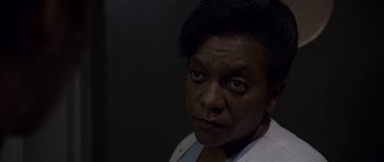 Movie still from “Halloween: Resurrection” (2002), directed by Rick Rosenthal – An older black woman with short black hair looking at the camera; Close Up shot, High angle