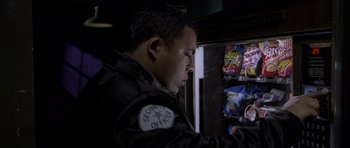 Movie still from “Halloween: Resurrection” (2002), directed by Rick Rosenthal – A man wearing a black jacket looking at a vending machine; Close Up shot, High angle