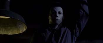 Movie still from “Halloween: Resurrection” (2002), directed by Rick Rosenthal – A man with a mask is posing for a picture; Close Up shot, Low angle