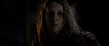 Movie still from “Halloween: Resurrection” (2002), directed by Rick Rosenthal – A person holding a knife; Close Up shot, Low angle