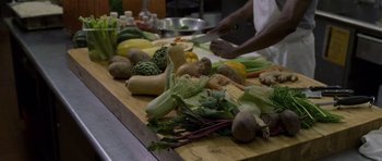 Movie still from “Halloween: Resurrection” (2002), directed by Rick Rosenthal – A person cutting vegetables on top of a wooden cutting board; Extreme Close Up shot, High angle
