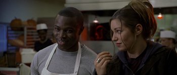 Movie still from “Halloween: Resurrection” (2002), directed by Rick Rosenthal – A man and a woman standing next to each other in a kitchen; Close Up shot, Over the shoulder angle