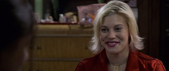 Movie still from “Halloween: Resurrection” (2002), directed by Rick Rosenthal – A woman with blonde hair smiles for the camera; Close Up shot, Over the shoulder angle