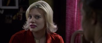 Movie still from “Halloween: Resurrection” (2002), directed by Rick Rosenthal – A woman in a red shirt is looking at the camera; Close Up shot, Over the shoulder angle