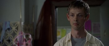 Movie still from “Halloween: Resurrection” (2002), directed by Rick Rosenthal – A man standing in front of a bathroom mirror; Close Up shot, Over the shoulder angle