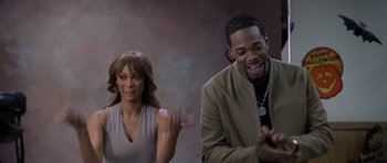 Movie still from “Halloween: Resurrection” (2002), directed by Rick Rosenthal – A man and a woman standing next to each other; Medium shot, Over the shoulder angle