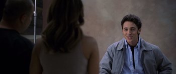 Movie still from “Halloween: Resurrection” (2002), directed by Rick Rosenthal – A man and a woman sitting in front of each other; Medium shot, Over the shoulder angle