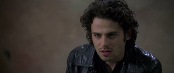 Movie still from “Halloween: Resurrection” (2002), directed by Rick Rosenthal – A person wearing a leather jacket; Close Up shot, Over the shoulder angle